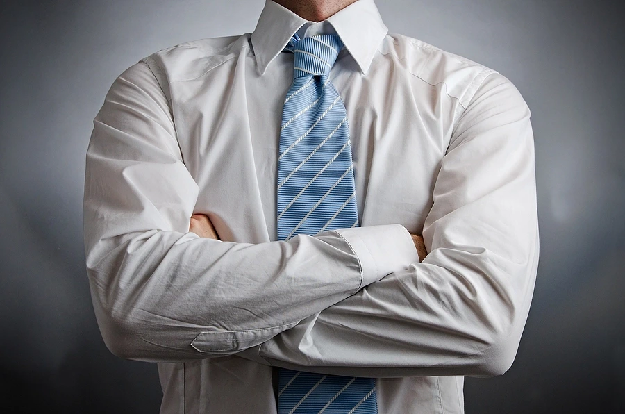 Man in white shirt with folded arms