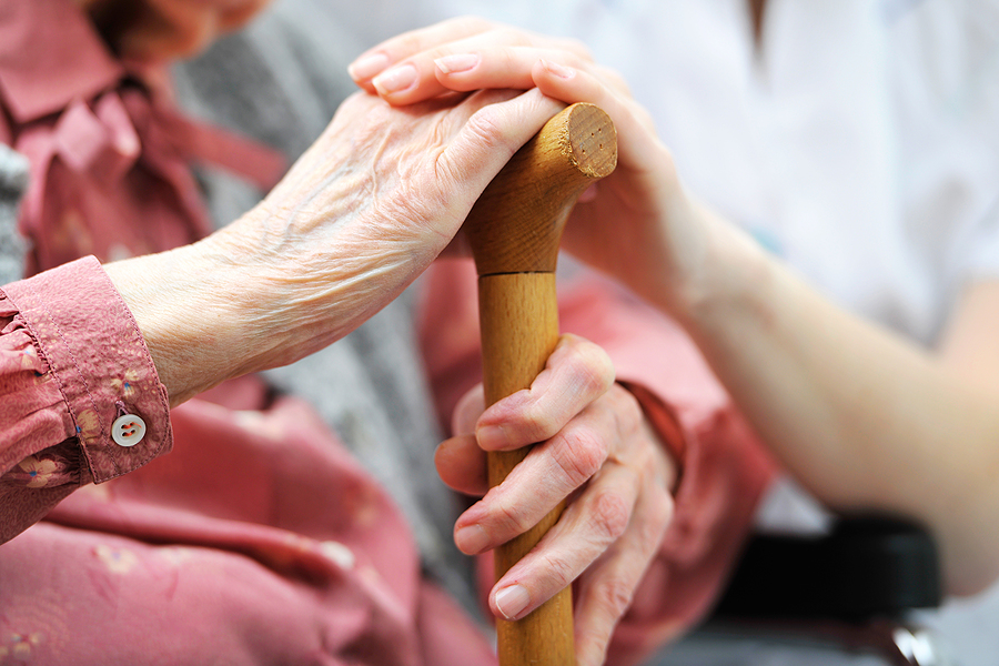 Senior woman with her caregiver at home